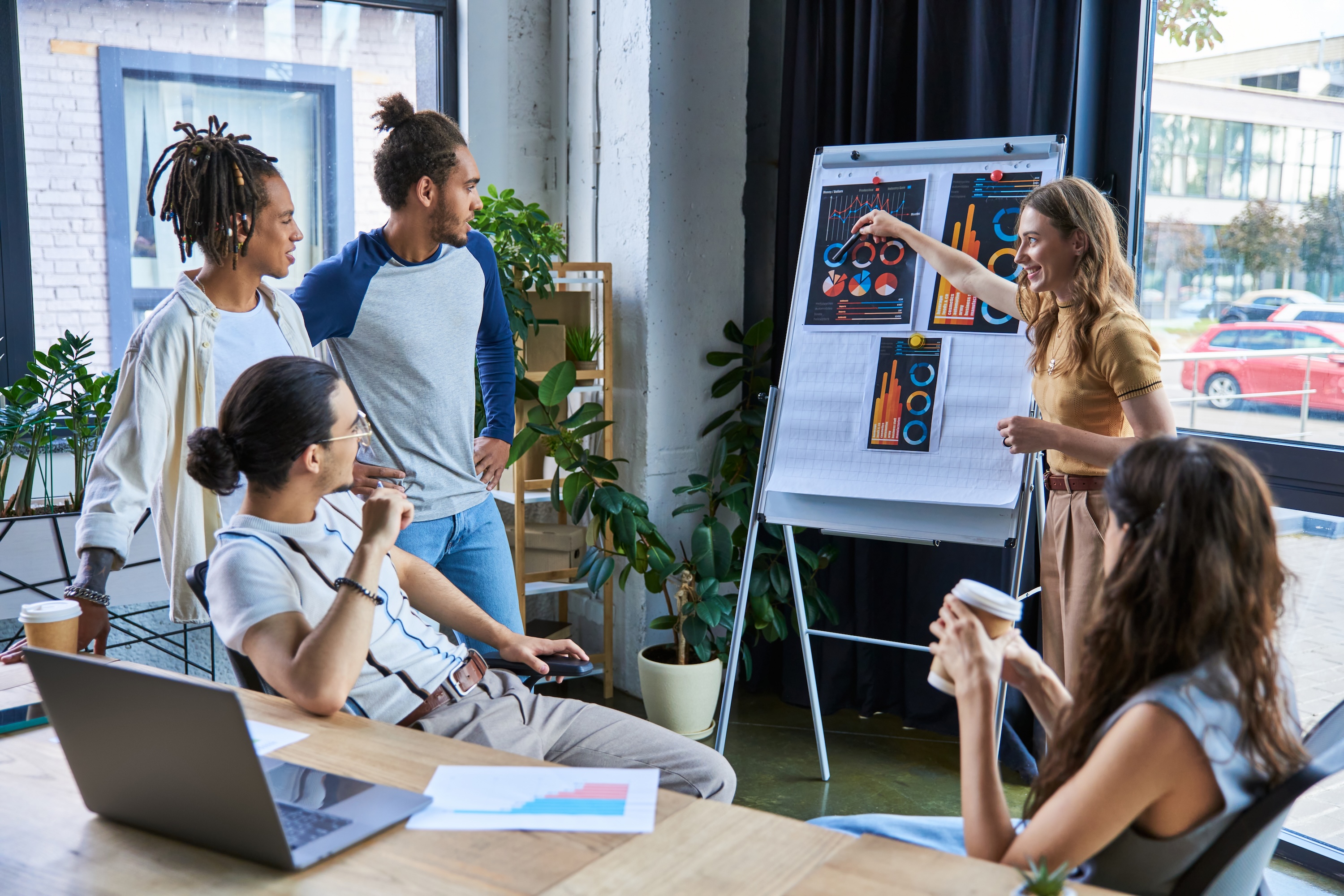 Business woman pointing at flip chart and discussing analytics