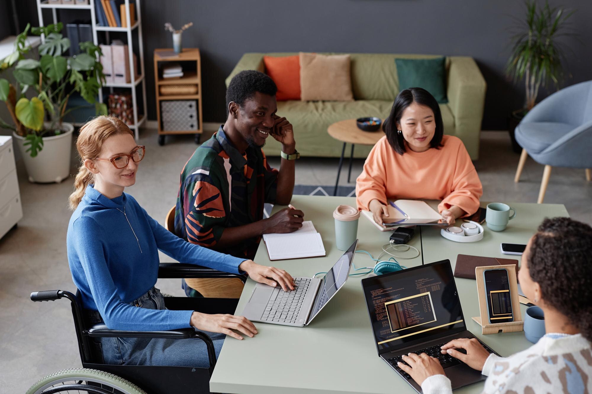 Young diverse team meeting at a table in the office
